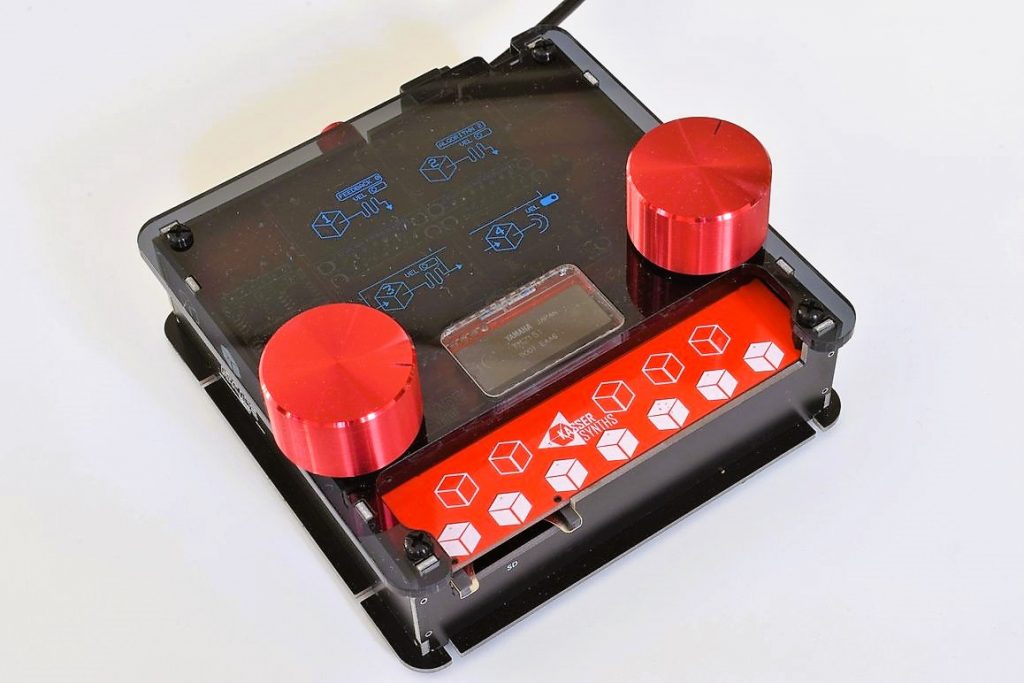 DAFM Arcade synth with black acrylic case, red knobs and a smoked top